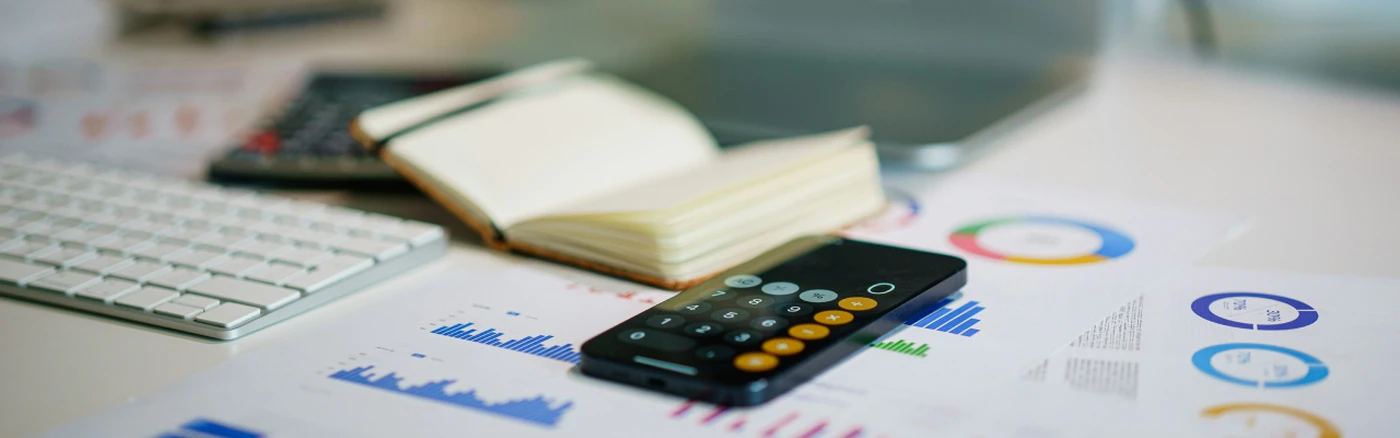 Calculator, laptop and charts