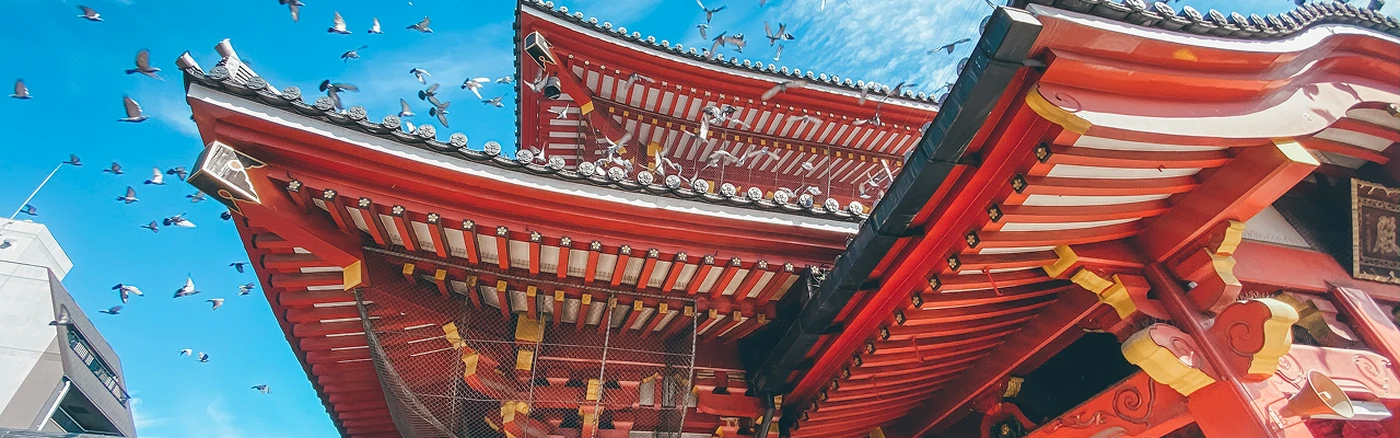 close-up of a Japanese pagoda building against a blue sky