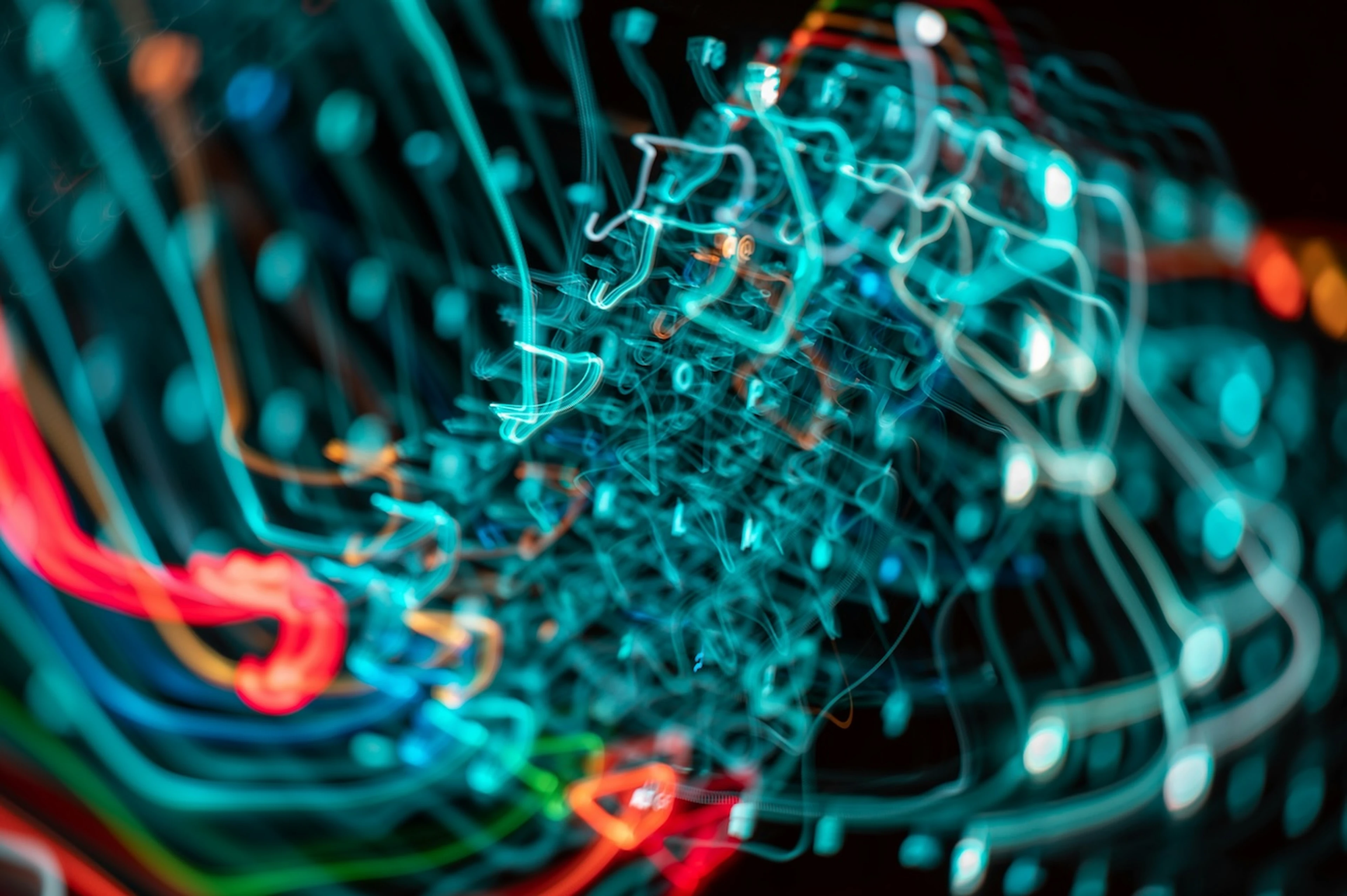 Vibrant teal and red neon light trails create a tangled, geometric pattern dark background. It represents complex data and AI.
