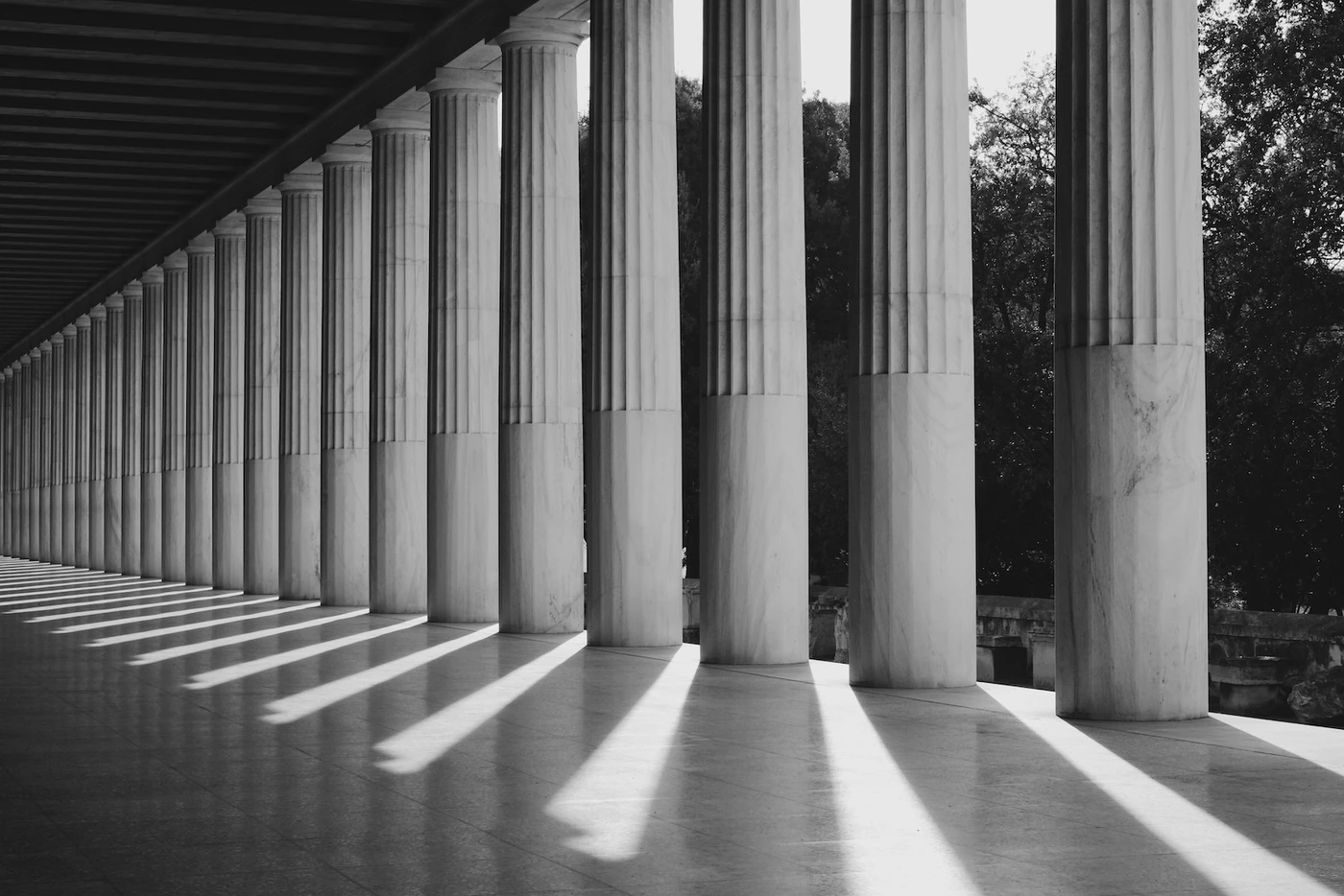 black-and-white photo of a walkway with pillars