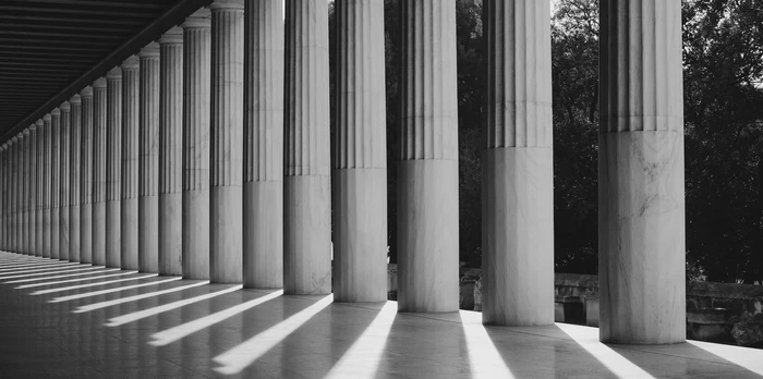 black-and-white photo of a walkway with pillars