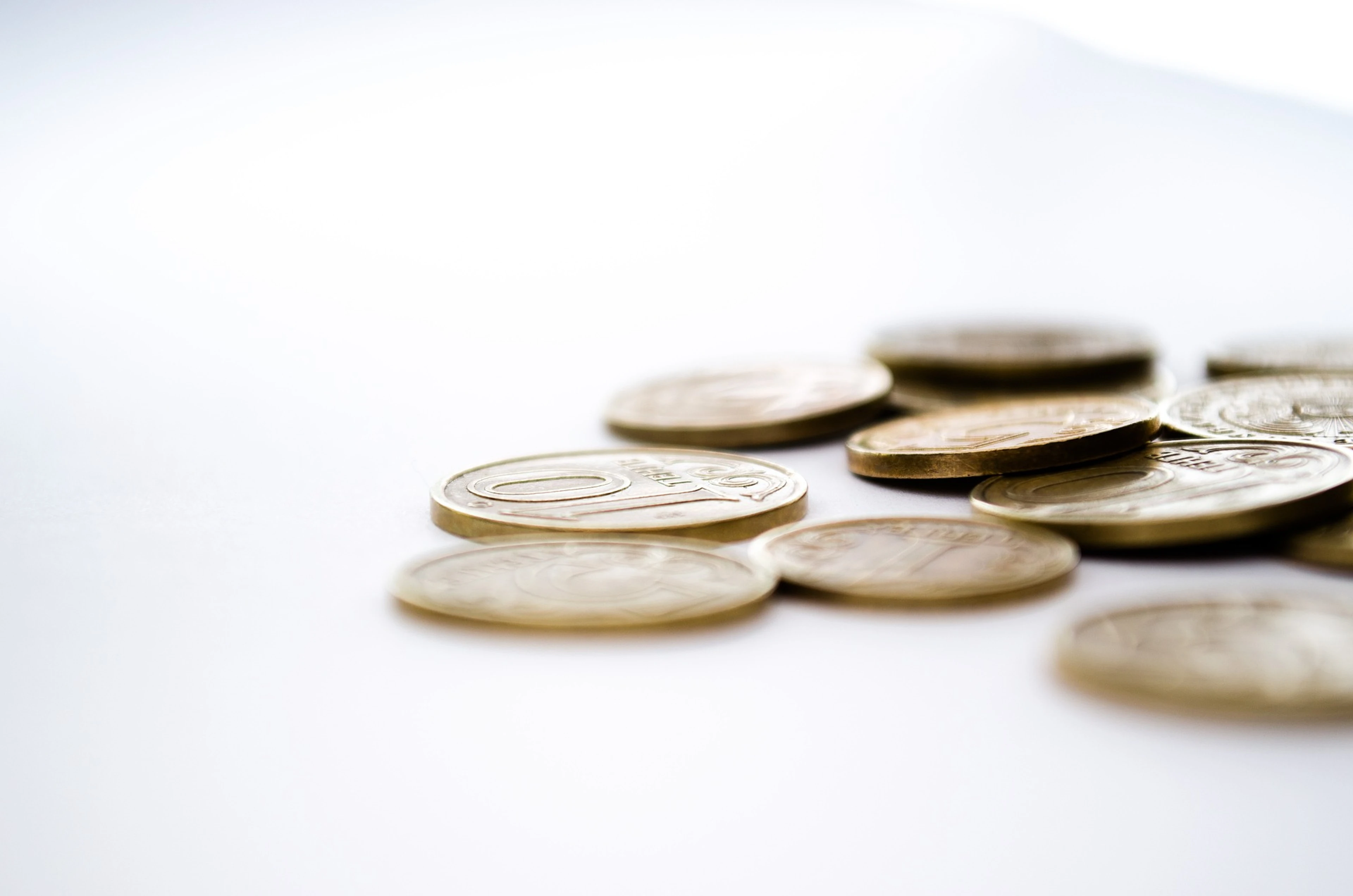 A scattered pile of euro coins on a white surface, symbolising hotel budget season