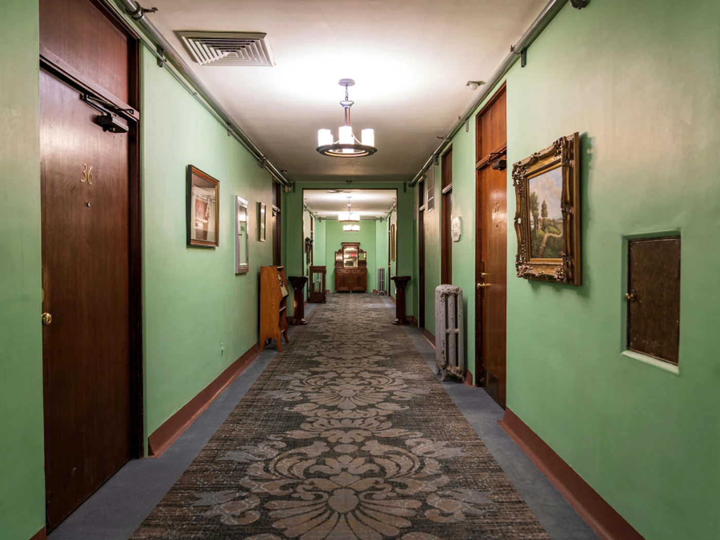 A hotel corridor with rooms on either side