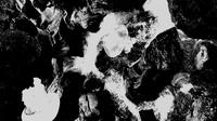 Abstract black and white image with swirling patterns and contrasting textures, resembling smoke and rocks.