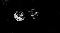 Two abstract, circular shapes with textured surfaces against a black background, resembling celestial bodies or artistic interpretations of planets.