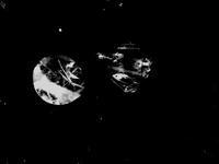 Two abstract, circular shapes with textured surfaces against a black background, resembling celestial bodies or artistic interpretations of planets.