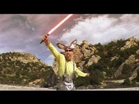 Person in a bunny costume wielding a red lightsaber, standing outdoors with rocky hills and a cloudy sky in the background.