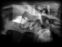 A ghostly, abstract dancing women in motion, with flowing fabric, creates a sense of ethereal movement in a dark, blurred environment.