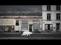 A polar bear silhouette walks across a deserted, graffiti-covered urban street with dilapidated buildings under a dark sky.