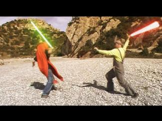 Two people, one in carrot and one in a rabbit costume, in a rocky landscape are engaged in a lightsaber duel, one with a green blade and the other with a red blade.
