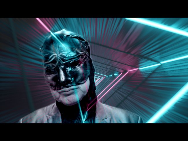 Person in a black mask stands in a neon-lit tunnel with dynamic pink and blue light trails.