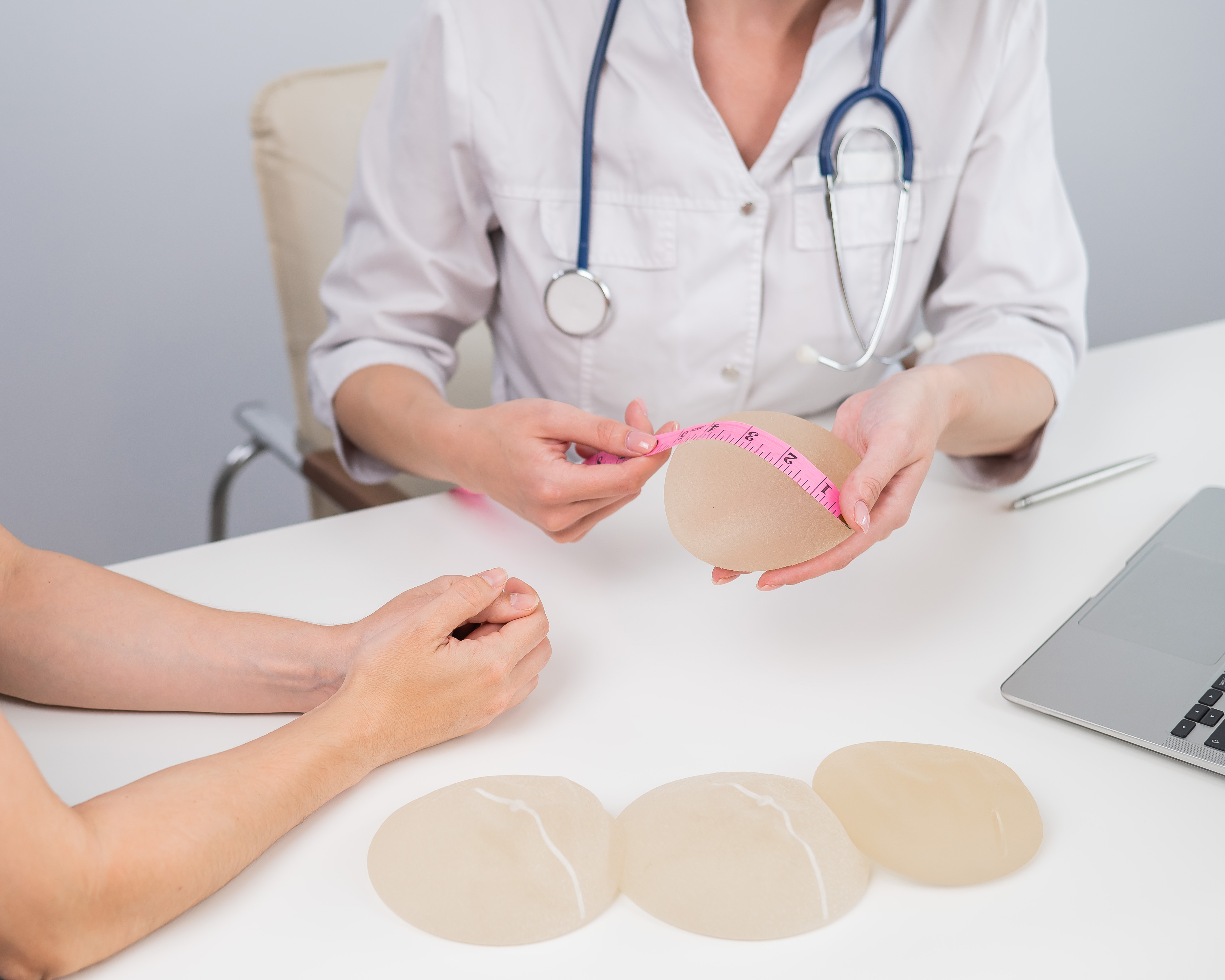 Dr measuring a Breast implant for a patient