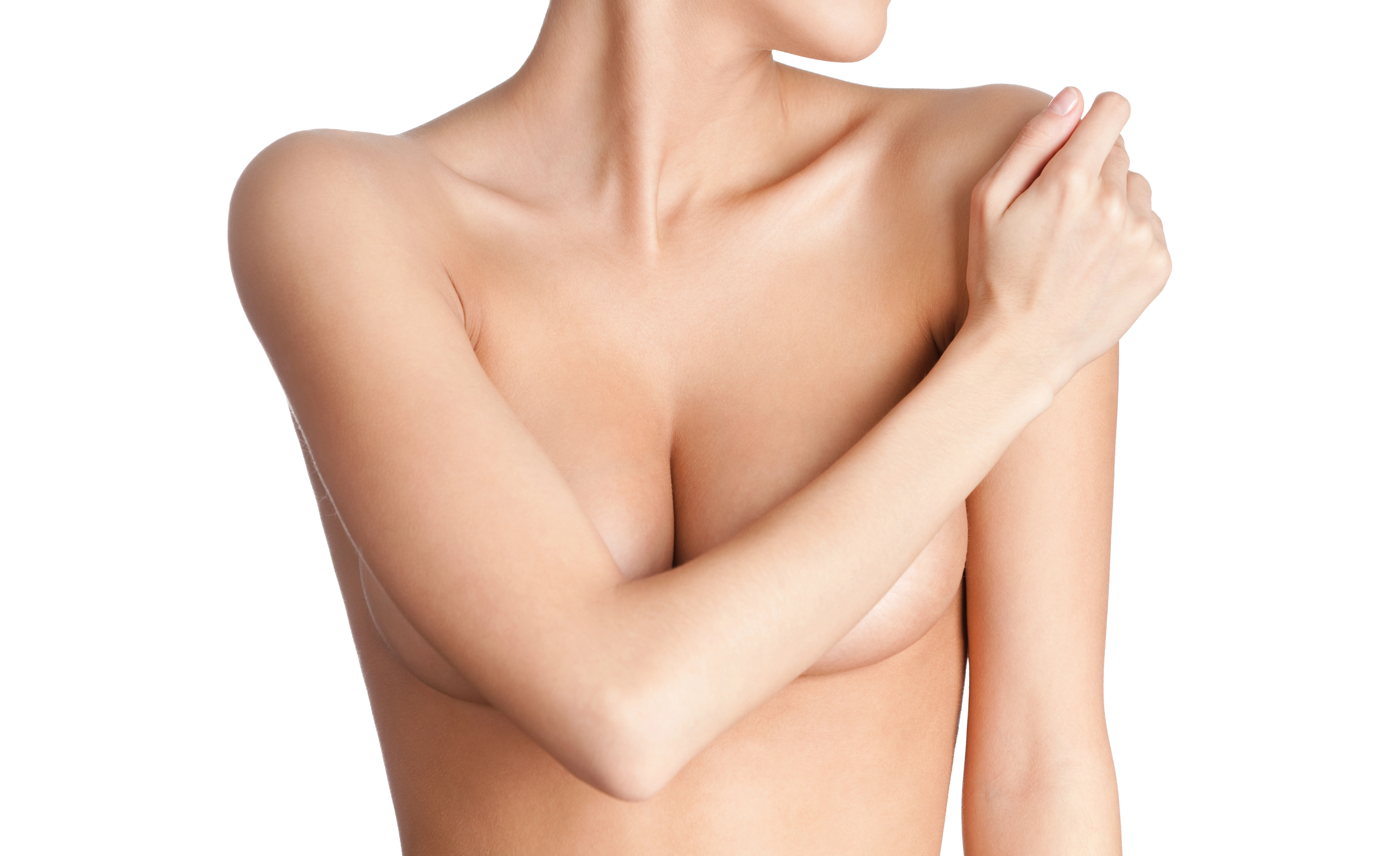 A woman with bare shoulders and chest, covering her breast with one hand, against a plain white background.