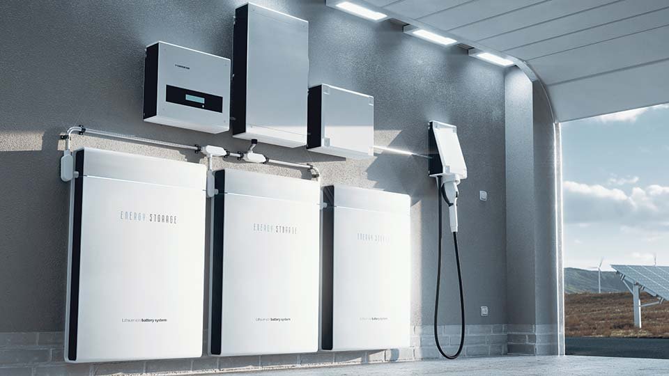 Wall-mounted energy storage units and a charging station in a modern garage, with solar panels visible outside.