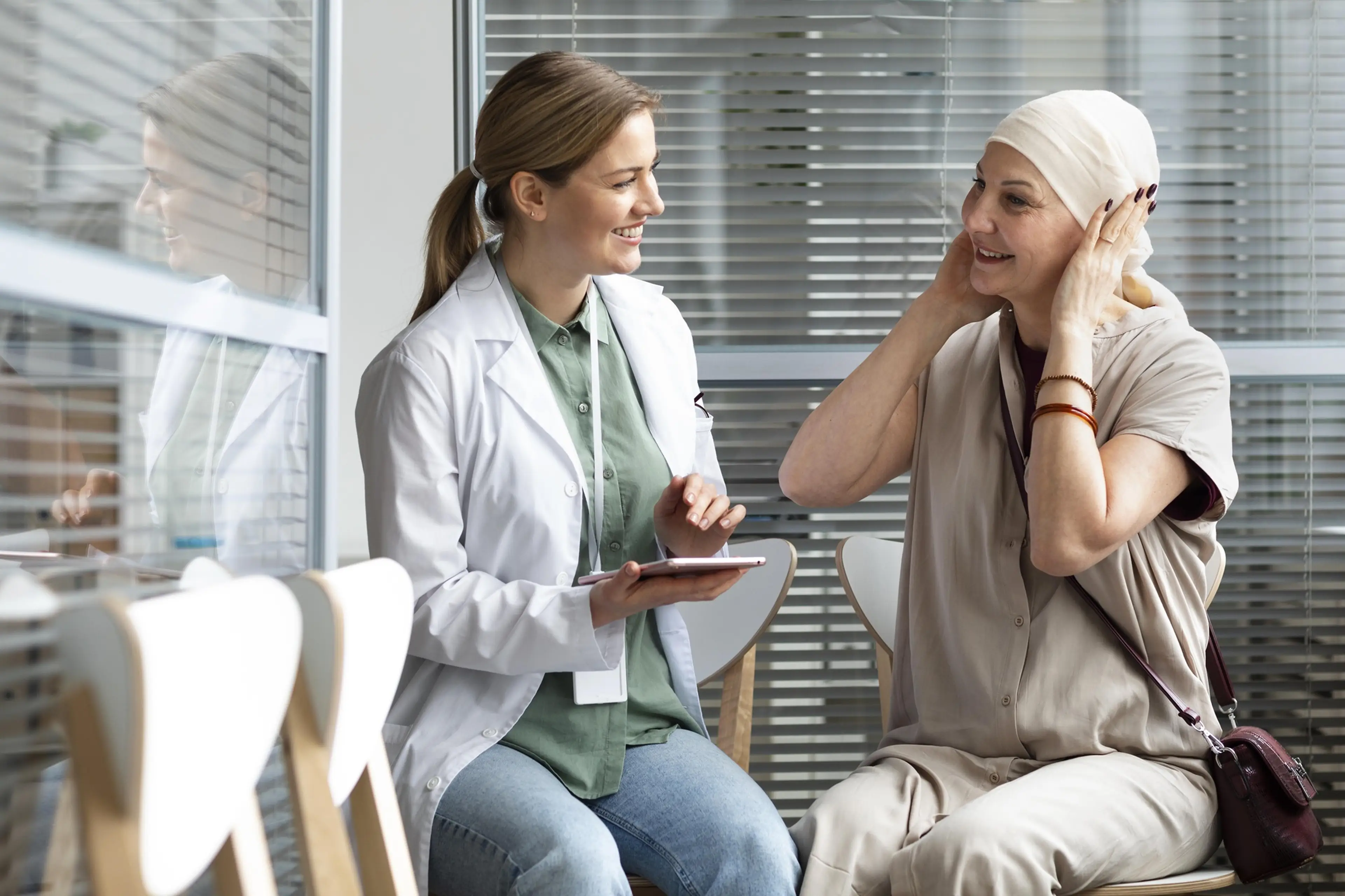 Middle age woman with cancer talking to a doctor