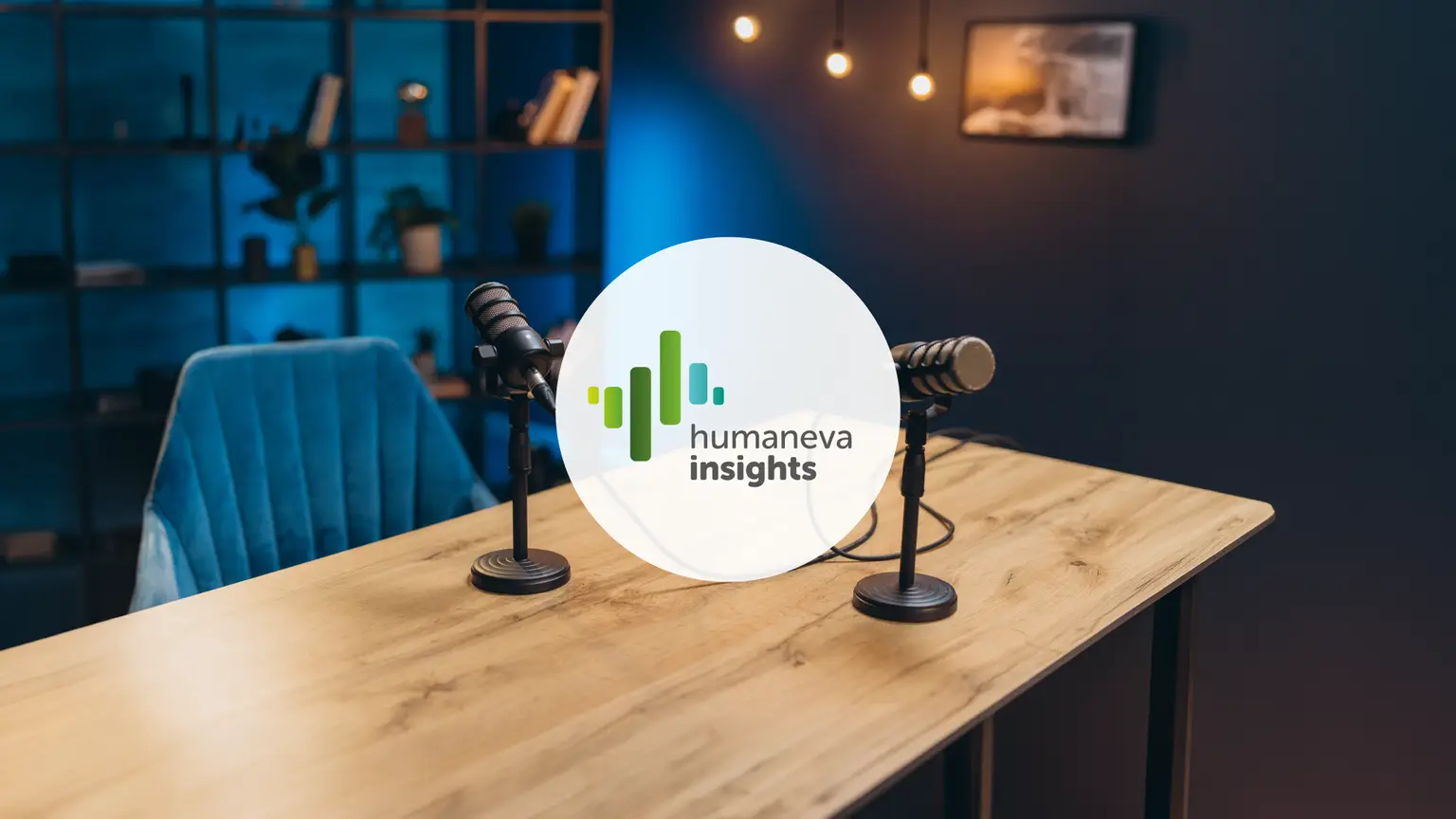 Podcast studio setup with two microphones on a wooden table, a blue chair, and a circular "humaneva insights" logo overlay.