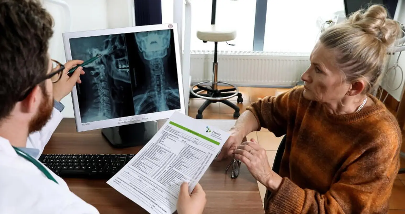 Doctor explaning X Ray image to the patient during Osteobus Campaign in Poland