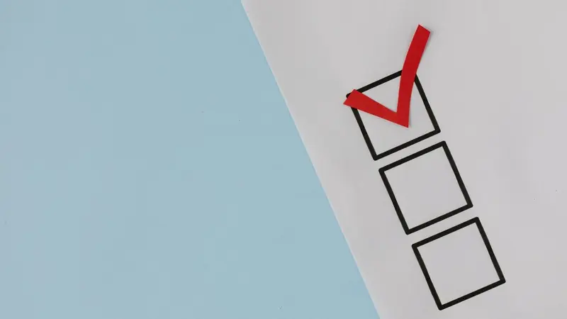 Checklist boxes on paper with the first box ticked in red