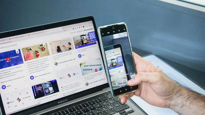 Laptop and smartphone both showing social media feeds