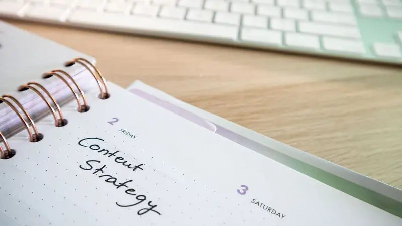 Notebook page titled Content Strategy on a desk