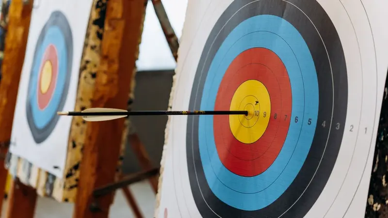 Arrow lodged in the center of an archery target