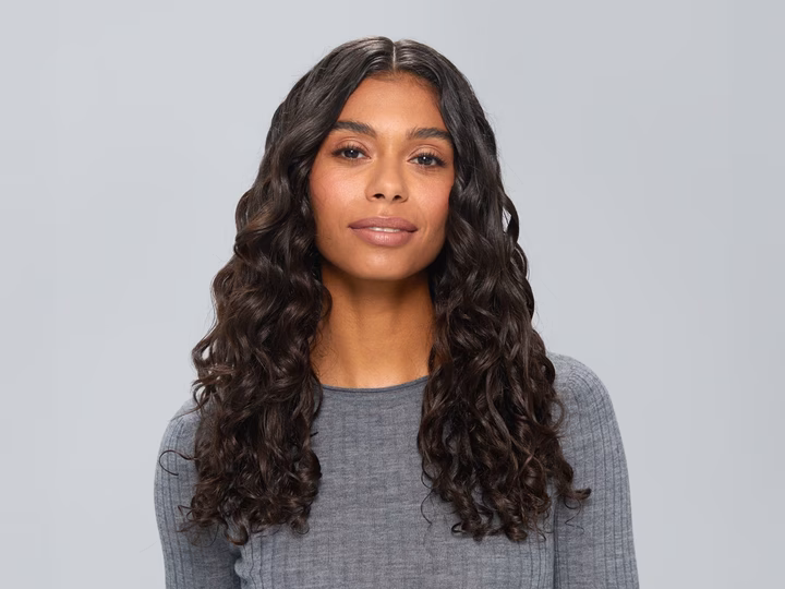 Portrait of woman with curly hair after using Braun HD4.3 Hairdryer.