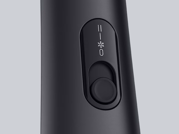 Close-up of Braun Air styler control switch with temperature and speed settings.