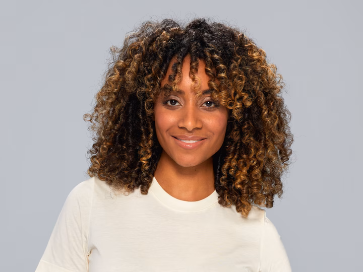 Portrait of woman with curly hair after using Braun HD4.3 Hairdryer.