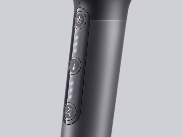 Close-up of Braun Hairdryer handle showing speed, temperature, and cool air control buttons.