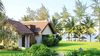 Luxury bungalow at Palm Garden Resort, surrounded by palm trees on the beautiful shores of Cua Dai – the serene setting for a Madhukar Yoga of Silence retreat in Vietnam.