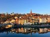 View of Laufenburg’s old town on the Rhine with reflections on the water—setting around the Hermitage retreat with Madhukar Enlighten Life.