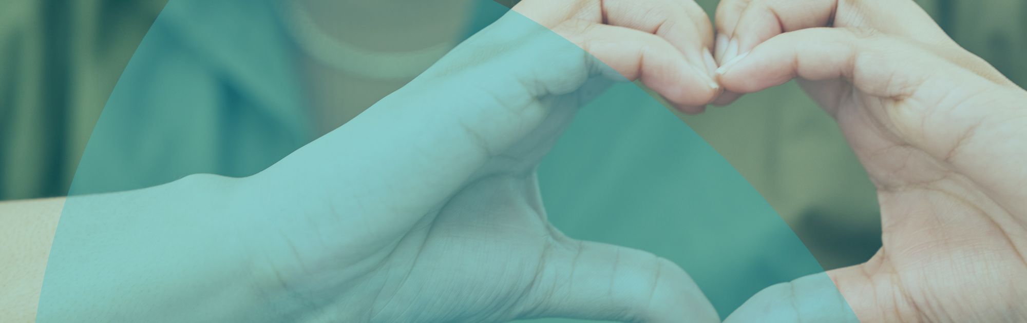 Person in a green shirt forming a heart shape with their hands, smiling softly, with an abstract blue overlay.