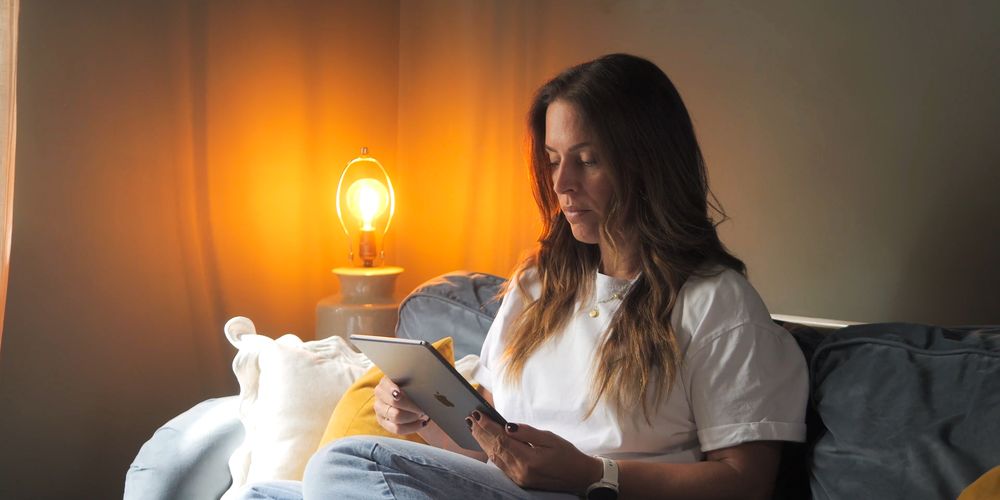 patient at home on sofa using ipad