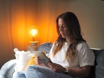 patient at home on sofa using ipad