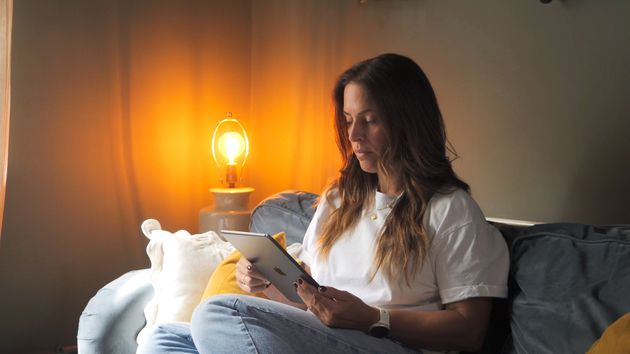 patient at home on sofa using ipad