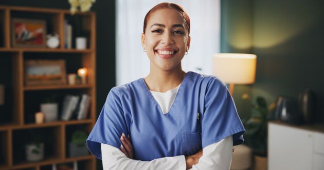 Happy Nurse in Patients Home