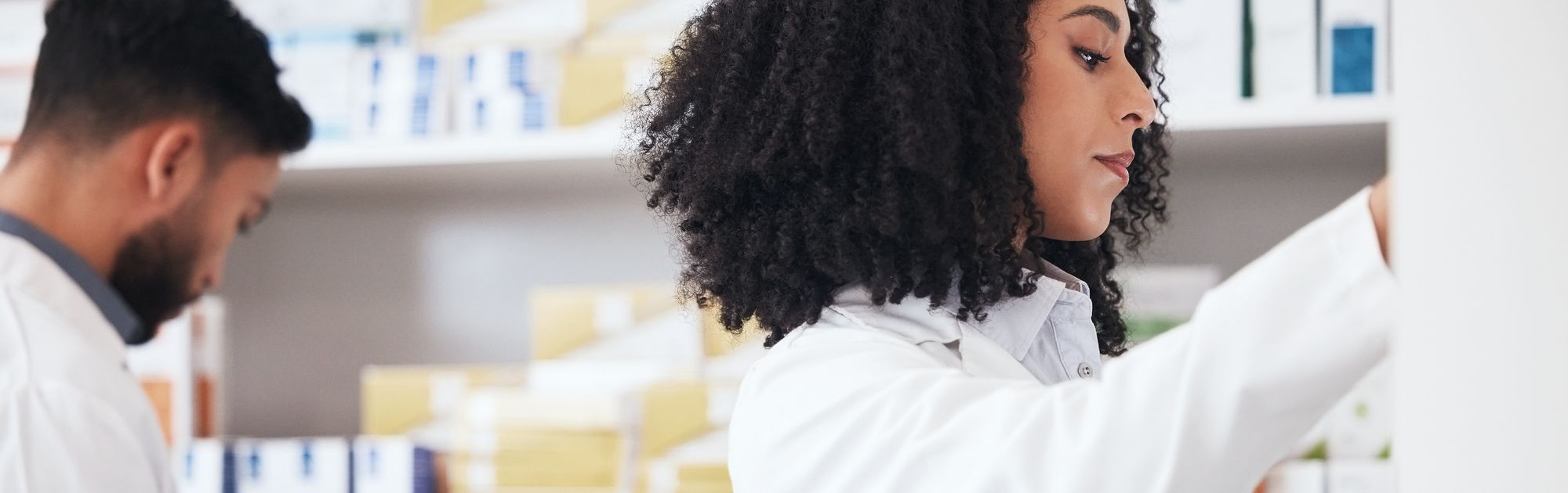 Workers in a pharmacy checking medicine