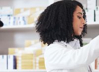Workers in a pharmacy checking medicine