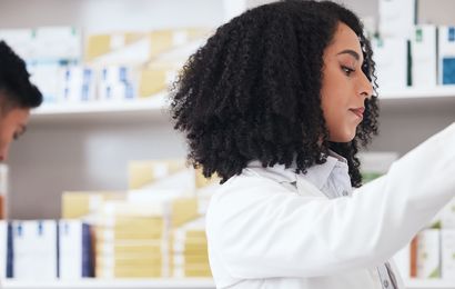 Workers in a pharmacy checking medicine