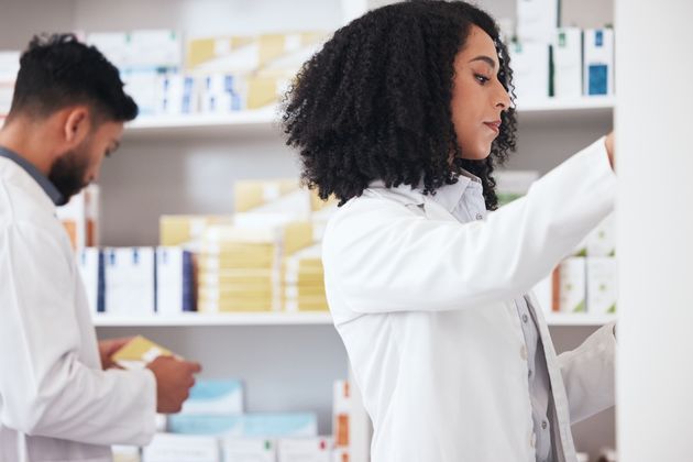 Workers in a pharmacy checking medicine