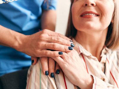 nurse visit at home - nurse with hand on patient shoulder