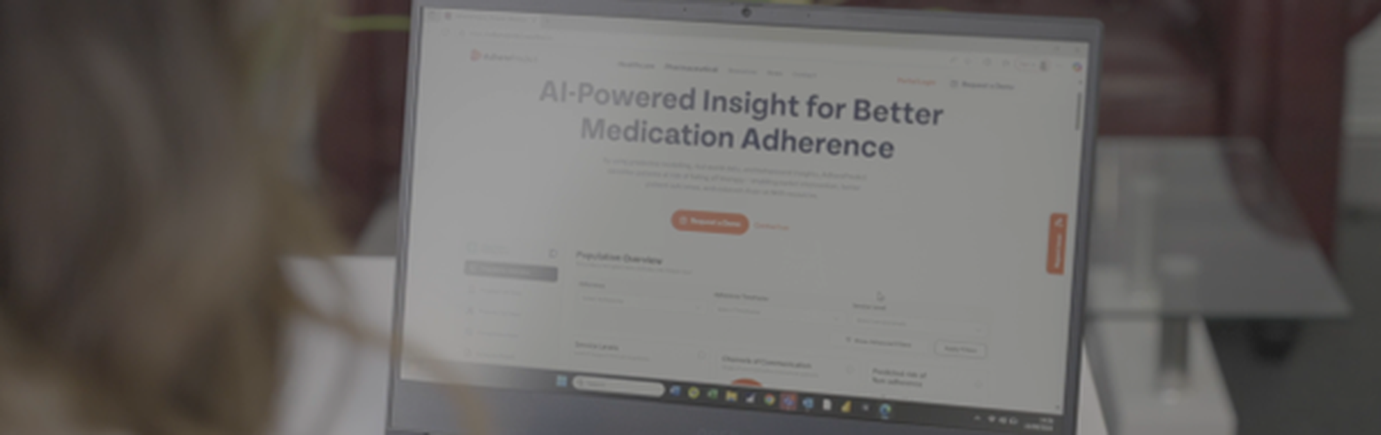 Person using a laptop displaying a webpage about AI-powered insights for better medication adherence.