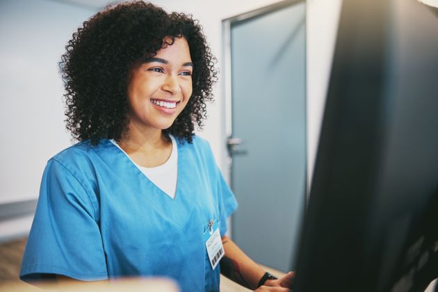 nurse typing on a computer in the hospital