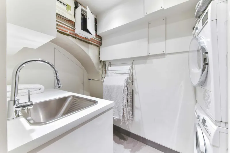 Bespoke utility and laundry room with sink and drying rack