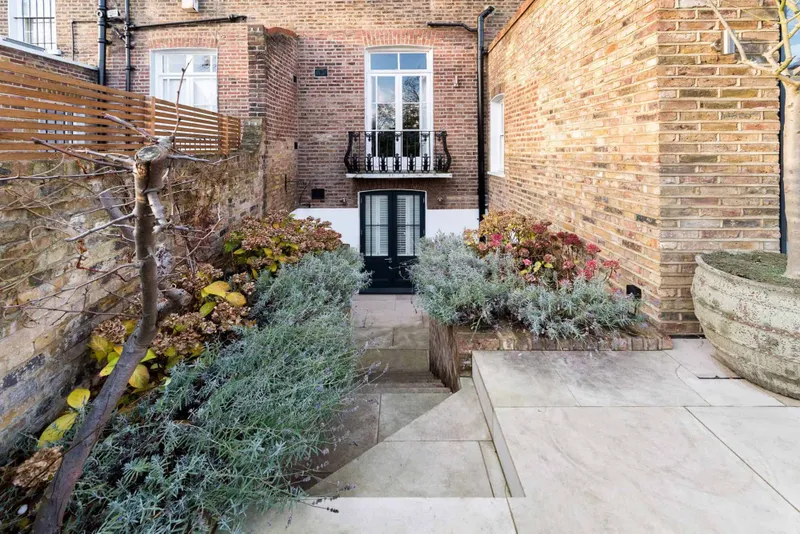 Side courtyard and lower-ground entrance