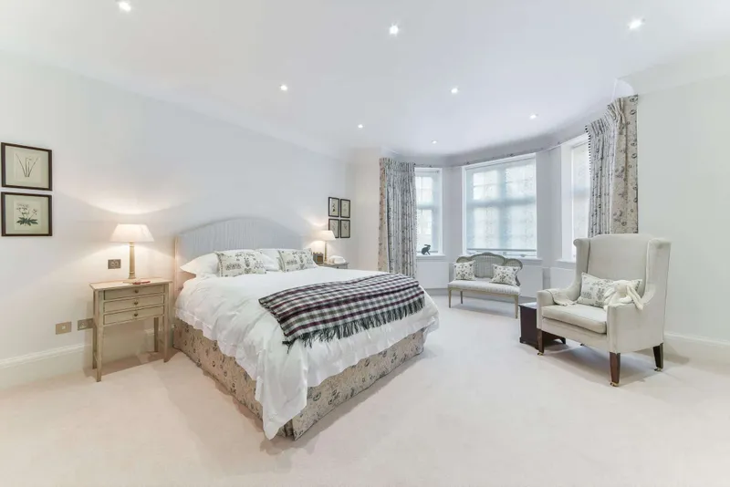 Principal bedroom with fitted wardrobes and bay window