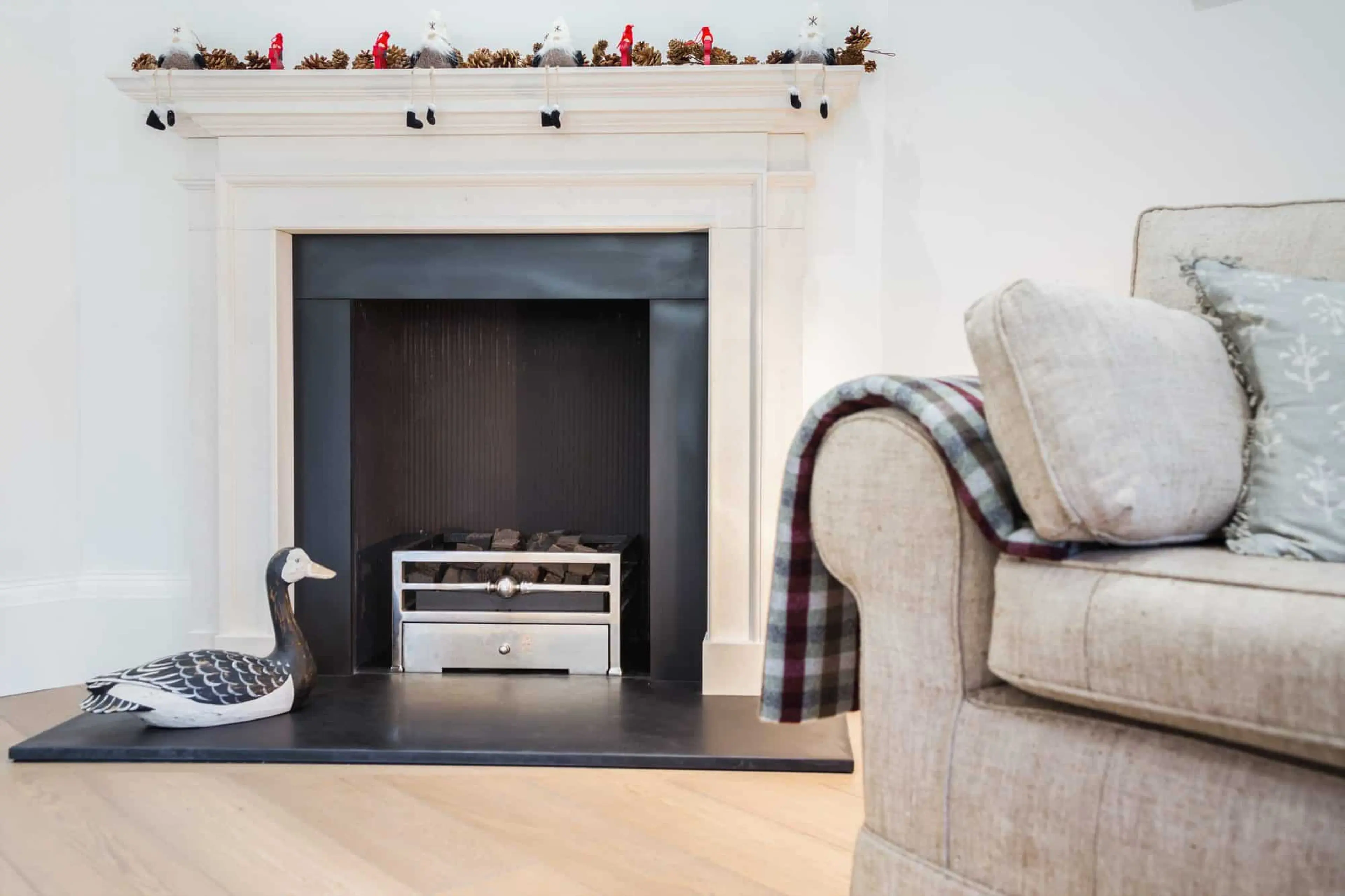 Reception room with reproduction period fireplace and real-flame basket fire