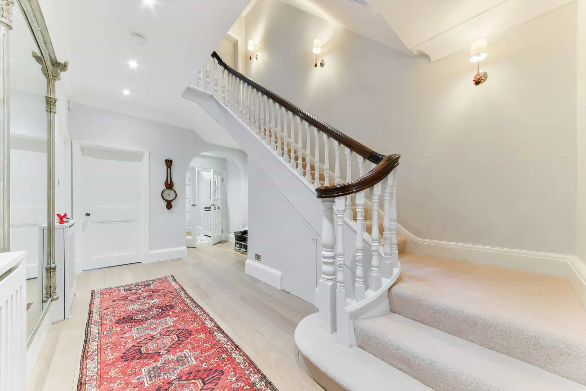 Entrance hall with French-polished oak staircase and antique mirror