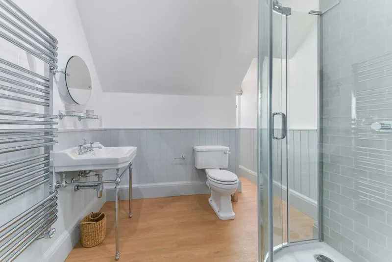 Shower room with tiled walls and heated towel rail