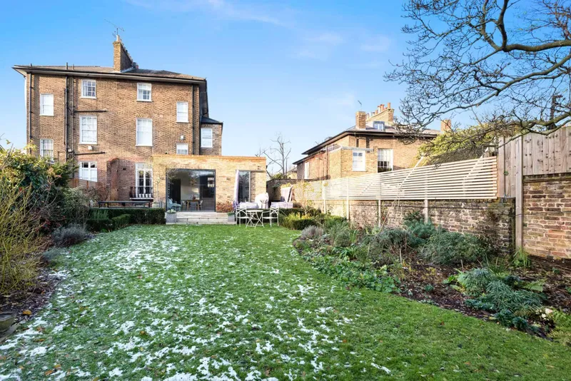 Rear elevation and garden, wide view with snow on the lawn